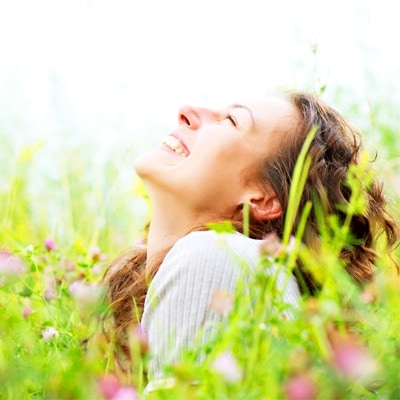 woman in meadow smiling